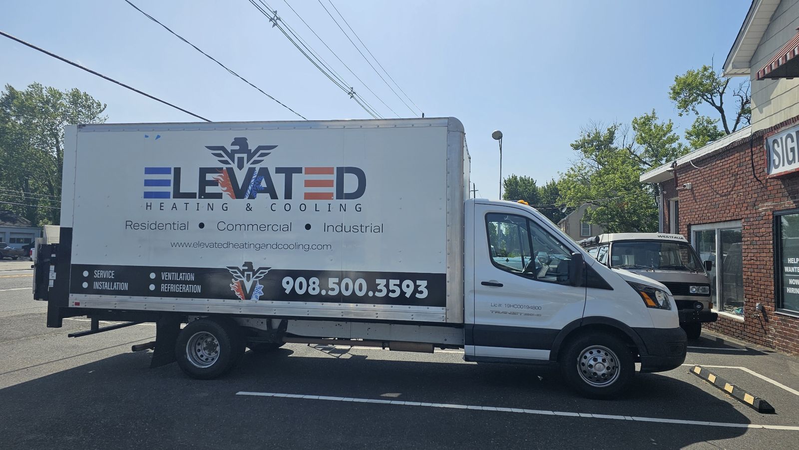 Box truck wrapped with the Elevated Heating & Cooling logo, services and phone number